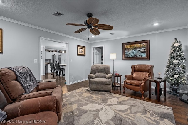 living room featuring a textured ceiling, dark hardwood / wood-style floors, ceiling fan, and crown molding