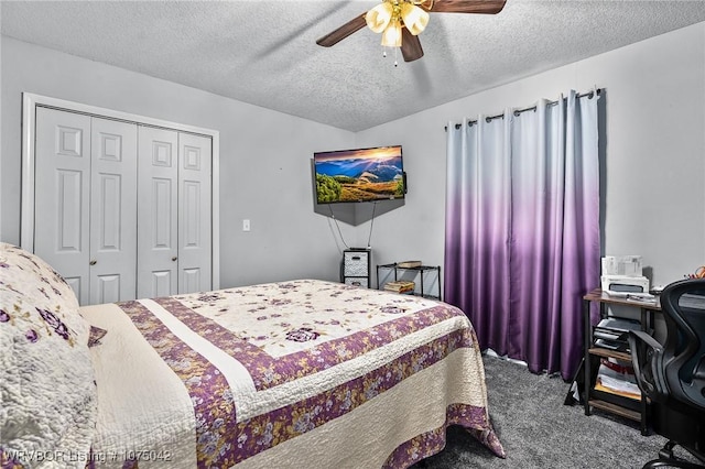 carpeted bedroom with ceiling fan, a closet, and a textured ceiling