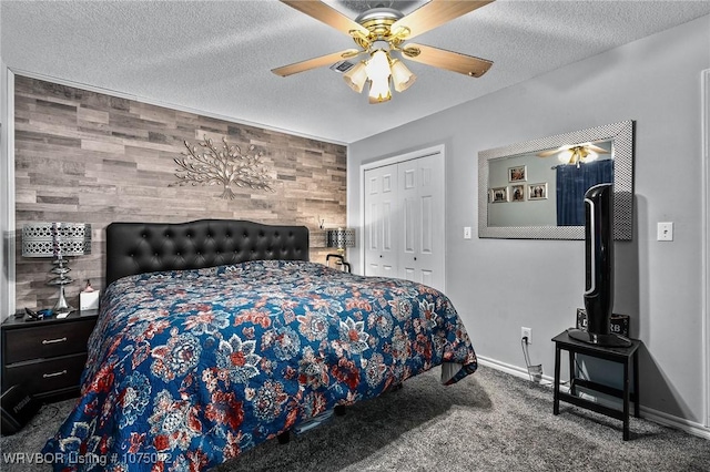 carpeted bedroom featuring ceiling fan, wood walls, a textured ceiling, and a closet