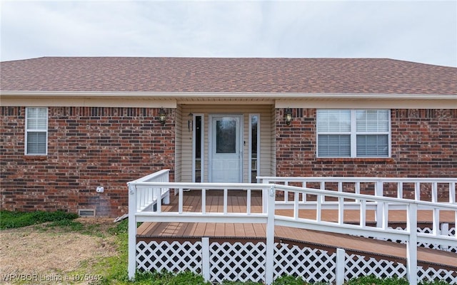 view of exterior entry with a wooden deck