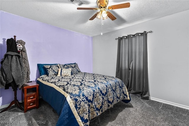 bedroom with ceiling fan, dark carpet, and a textured ceiling