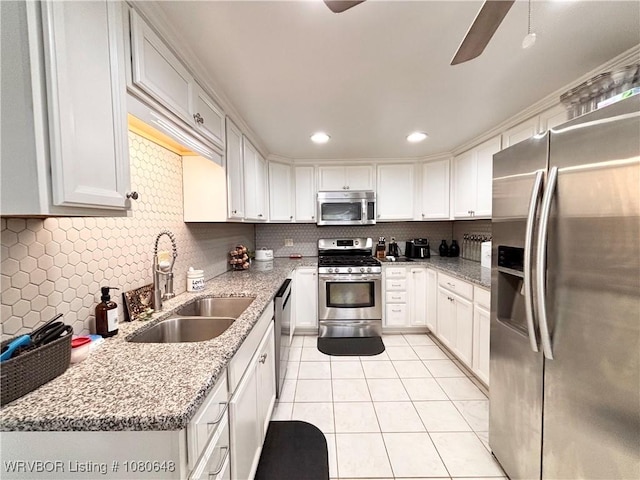 4245 W Piney Mountain Rd, Waldron, AR 72958 - kitchen featuring a sink, light tile patterned floors, decorative backsplash, and stainless steel appliances