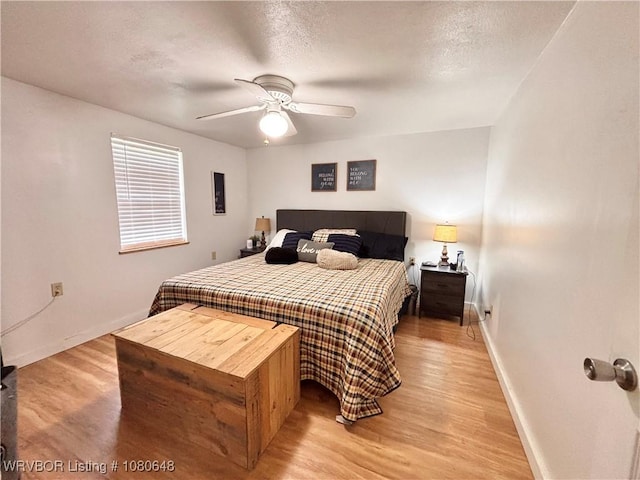 4245 W Piney Mountain Rd, Waldron, AR 72958 - bedroom with light wood-style floors, a ceiling fan, and baseboards