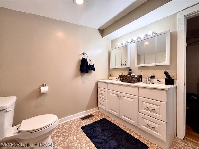4245 W Piney Mountain Rd, Waldron, AR 72958 - bathroom featuring visible vents, double vanity, baseboards, and toilet