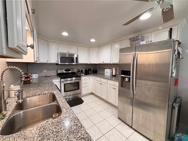 4245 W Piney Mountain Rd, Waldron, AR 72958 - kitchen with decorative backsplash, ceiling fan, white cabinets, a sink, and appliances with stainless steel finishes