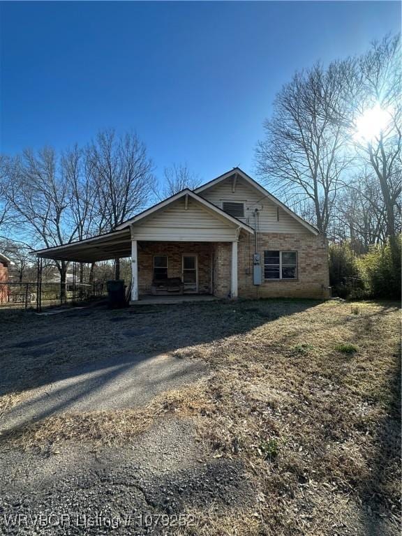 view of front of property with an attached carport and driveway