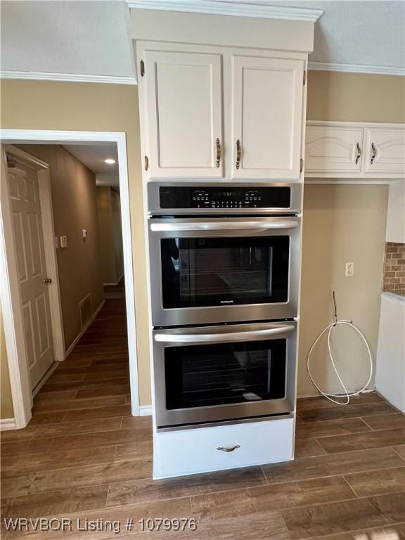 2205 Crosshill Rd, Fort Smith, AR 72908 - kitchen view of double oven, white cabinets, dark wood finished floors, and ornamental molding