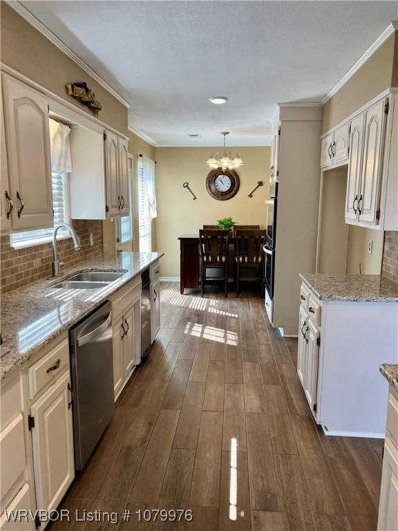 2205 Crosshill Rd, Fort Smith, AR 72908 - kitchen with appliances with stainless steel finishes, a sink, a chandelier, light stone countertops, and backsplash