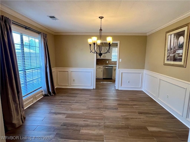 2205 Crosshill Rd, Fort Smith, AR 72908 - unfurnished dining area featuring a chandelier, healthy amount of natural light, a decorative wall, dark wood-type flooring, and wainscoting