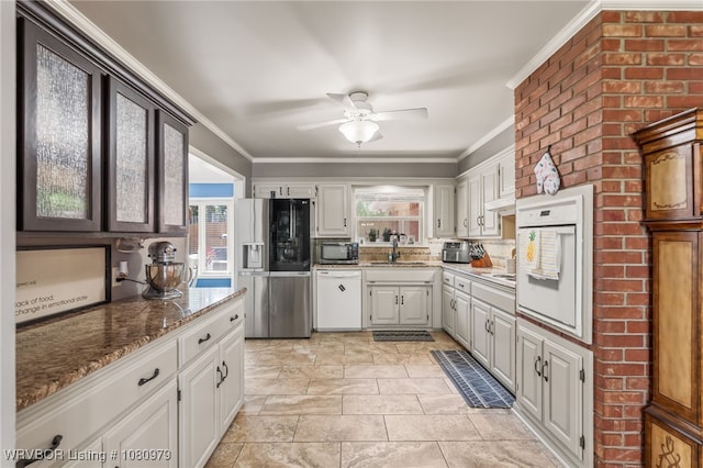 7118 S T St, Fort Smith, AR 72903 - kitchen with stainless steel appliances, a sink, ceiling fan, ornamental molding, and light stone countertops