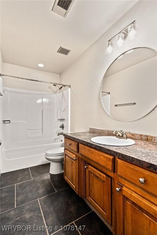 full bathroom featuring shower / bathing tub combination, vanity, and toilet