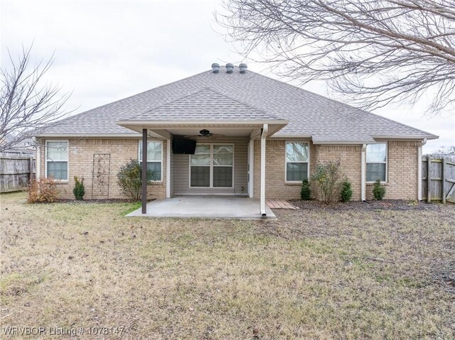 back of house with a lawn, a patio area, and ceiling fan