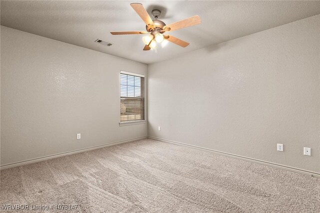 spare room with carpet and ceiling fan