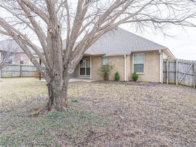 rear view of property featuring a yard