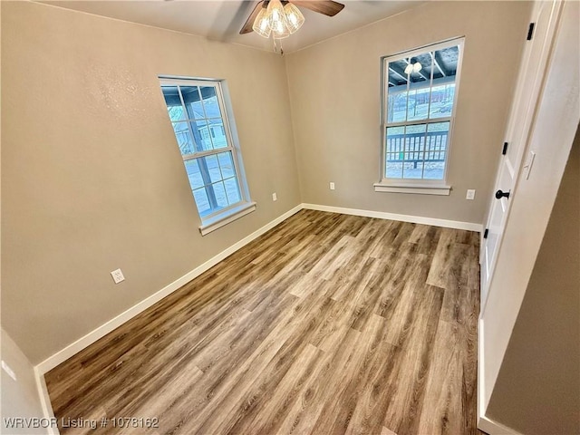 empty room featuring ceiling fan and light wood-type flooring