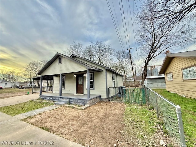 bungalow-style home featuring central air condition unit and covered porch