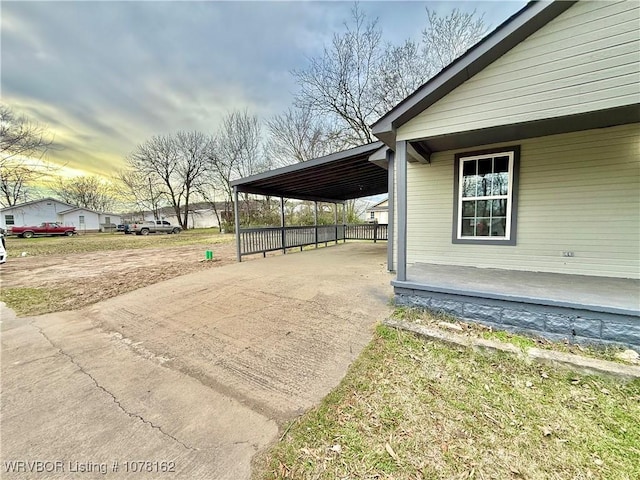 property exterior at dusk with a carport