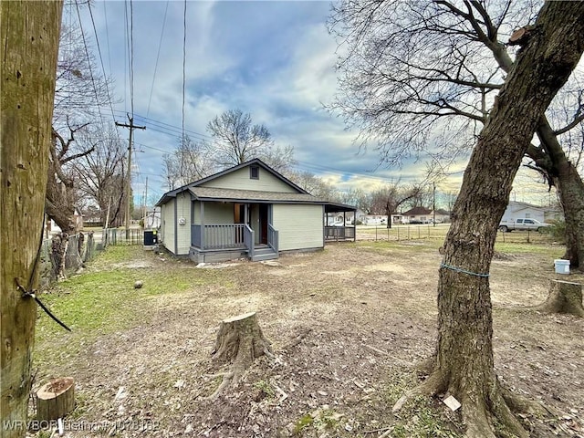 rear view of property featuring a porch