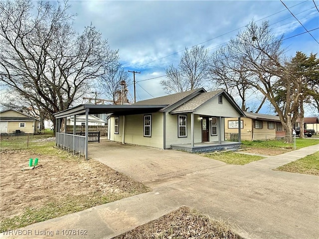 view of front of house featuring a carport and covered porch