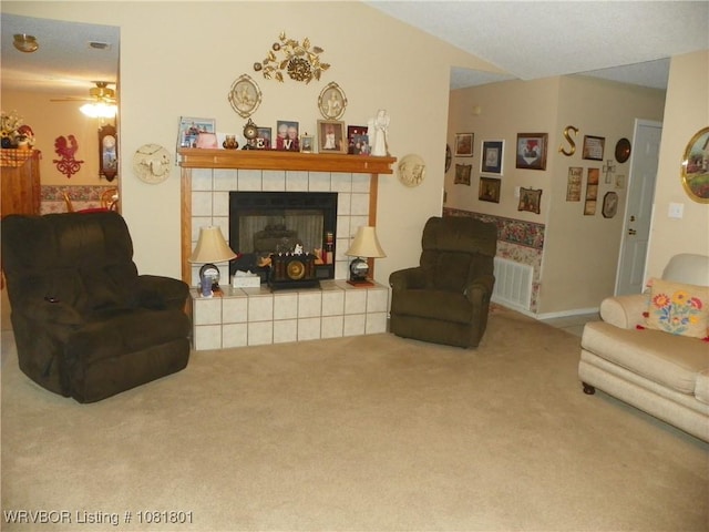 306 Crestview Dr, Van Buren, AR 72956 - carpeted living room featuring a tile fireplace and a ceiling fan