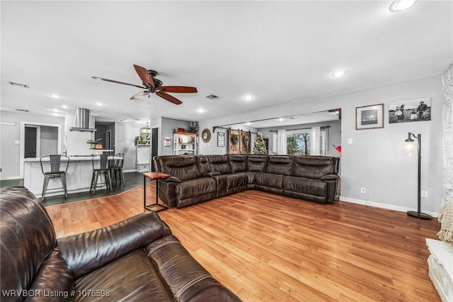 living room with ceiling fan and hardwood / wood-style flooring