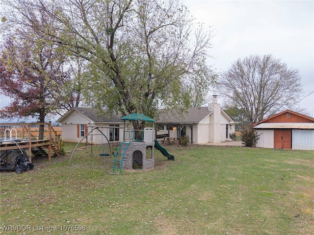 view of yard featuring a deck and a playground