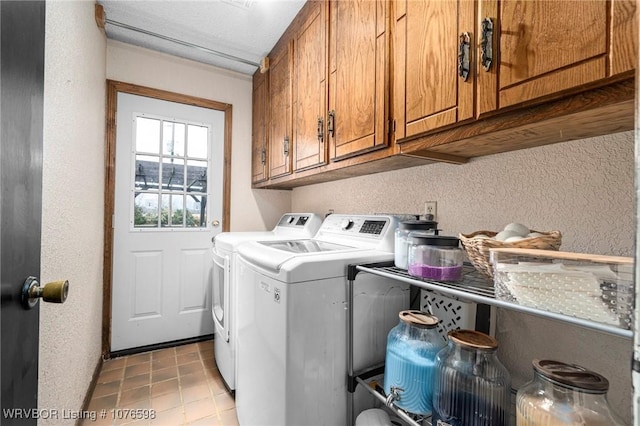 laundry room featuring cabinets and washing machine and dryer