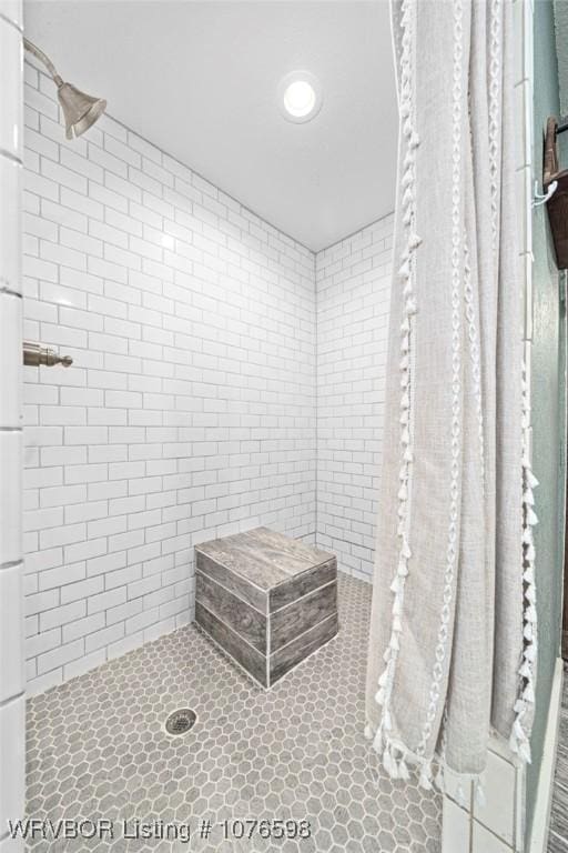 bathroom with a tile shower