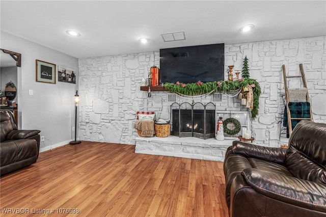 living room with hardwood / wood-style floors and a fireplace