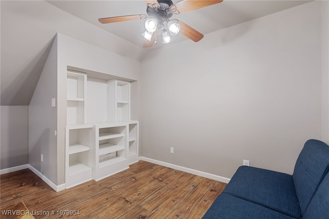 unfurnished room featuring baseboards, wood finished floors, and a ceiling fan