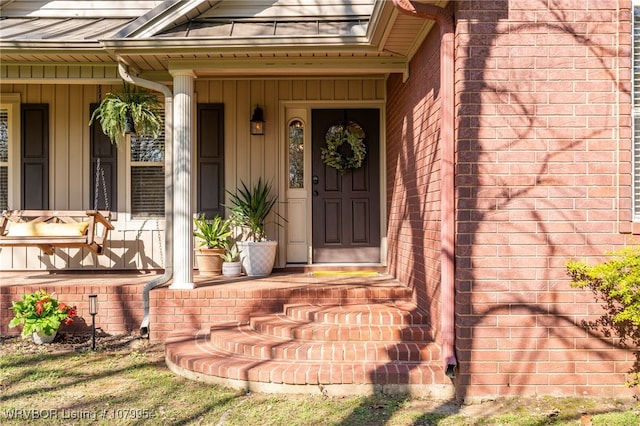 property entrance featuring brick siding