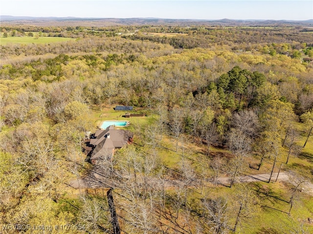 birds eye view of property featuring a view of trees