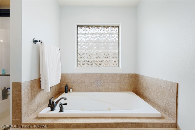 bathroom featuring tiled tub