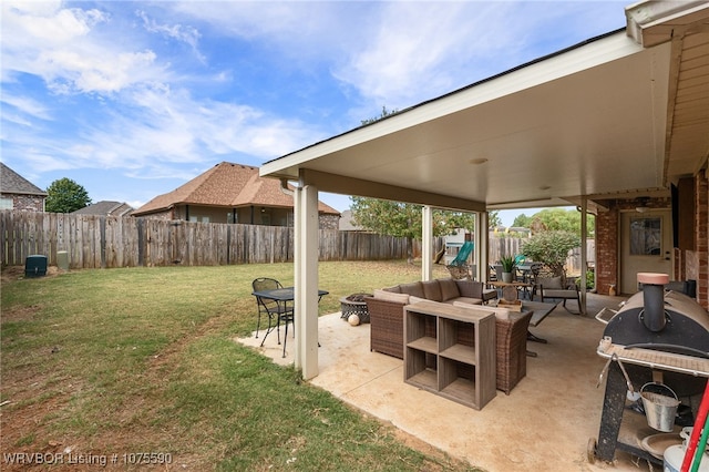 view of patio featuring grilling area and an outdoor living space with a fire pit