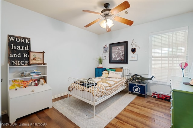 bedroom featuring hardwood / wood-style flooring and ceiling fan