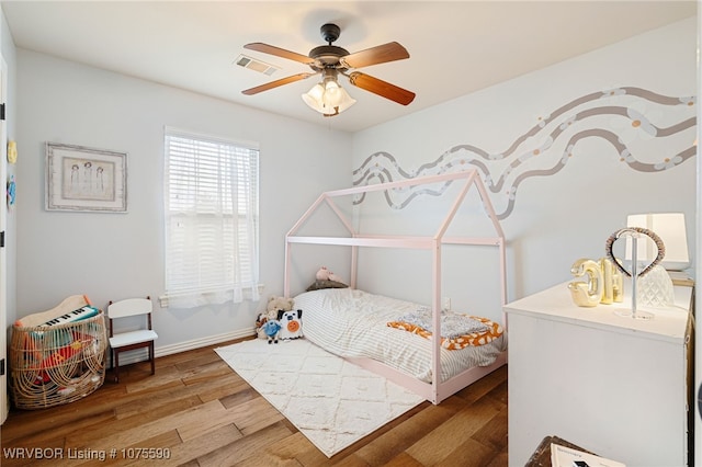 bedroom featuring ceiling fan and hardwood / wood-style flooring