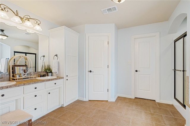 bathroom featuring vanity and an enclosed shower