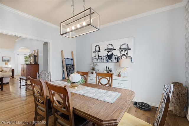 dining space with ornamental molding and hardwood / wood-style flooring