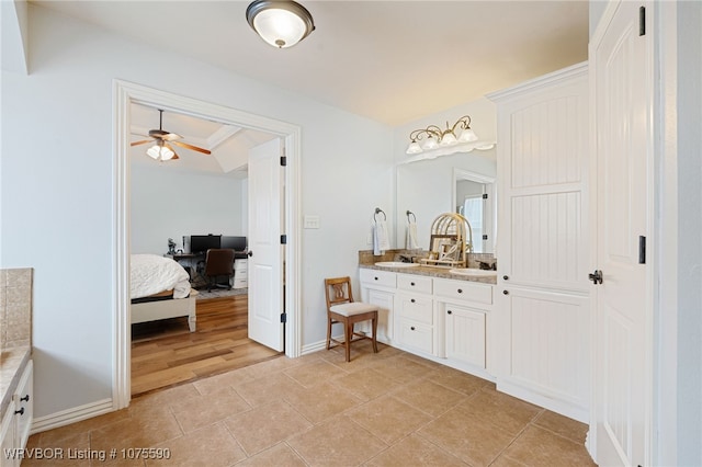 bathroom featuring vanity, ceiling fan, and crown molding