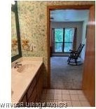700 Timber Ridge Rd, Howe, OK 74937 - bathroom with vanity, wallpapered walls, and tile patterned floors