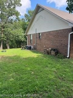 700 Timber Ridge Rd, Howe, OK 74937 - view of property exterior with brick siding and a yard