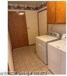 700 Timber Ridge Rd, Howe, OK 74937 - washroom featuring separate washer and dryer, cabinet space, and light tile patterned floors