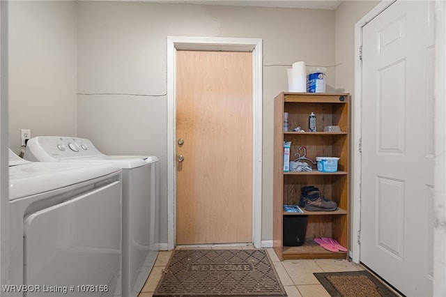 clothes washing area with light tile patterned floors and independent washer and dryer