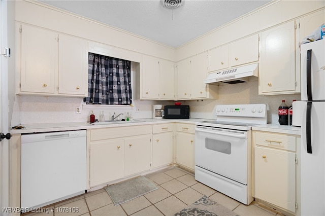 kitchen with white cabinets, white appliances, sink, and light tile patterned floors