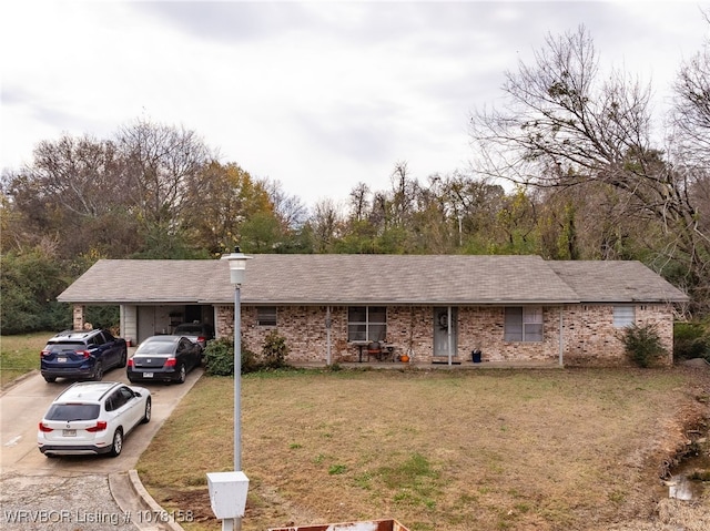 single story home featuring a front lawn and a carport