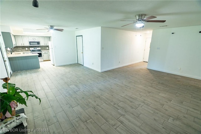 8617 S 15th St, Fort Smith, AR 72908 - unfurnished living room with a ceiling fan and light wood-style floors