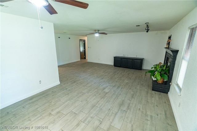 8617 S 15th St, Fort Smith, AR 72908 - unfurnished living room with ceiling fan, a brick fireplace, and light wood-style floors