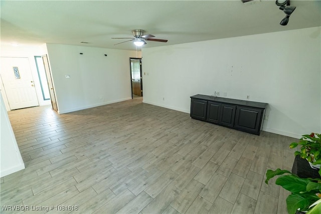 8617 S 15th St, Fort Smith, AR 72908 - unfurnished living room featuring a ceiling fan and light wood-style flooring