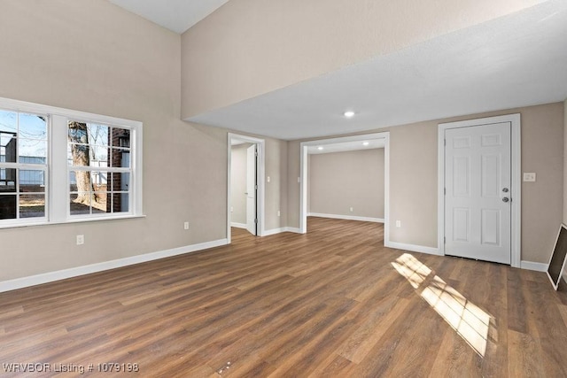 interior space featuring dark wood-style flooring, recessed lighting, and baseboards