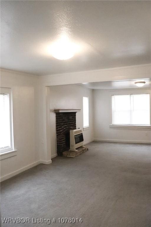 unfurnished living room with carpet floors and heating unit